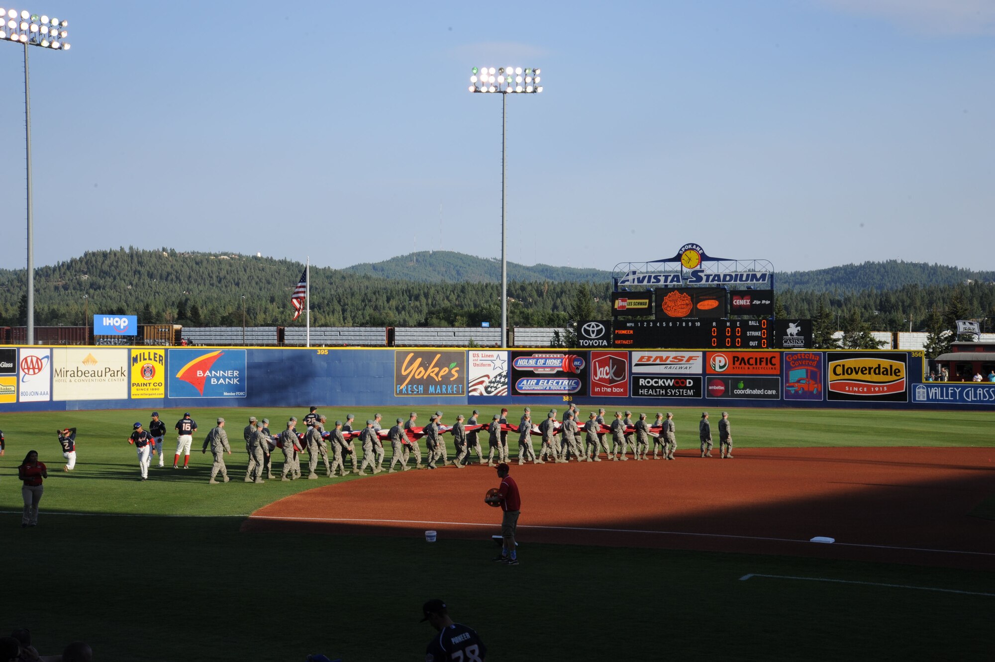 Members of Team Fairchild march the flag out prior to unfurling at Avista Stadium in Spokane, Wash., Aug. 4, 2015. The presentation of the flag was part of the preliminary schedule for the All-Star baseball game. (U.S. Air Force photo/Senior Airman Sam Fogleman)