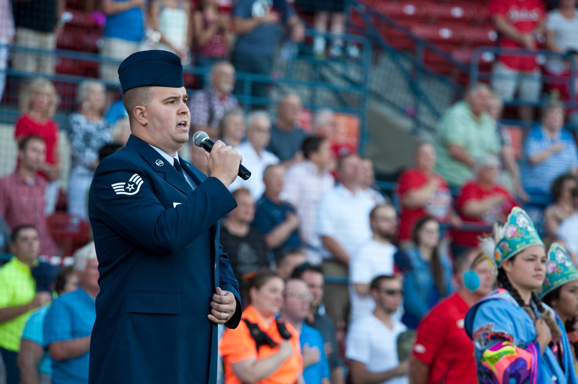 Staff Sgt. Timothy Slagle, 92nd Aircraft Maintenance Squadron dedicated crew chief, sings the Star-Spangled Banner at Avista Stadium in Spokane, Wash., Aug. 4, 2015. Slagle’s singing was among the preliminary events at the All-Star game for the Short Season Single A baseball leagues. (U.S. Air Force photo/Airman Sean Campbell)