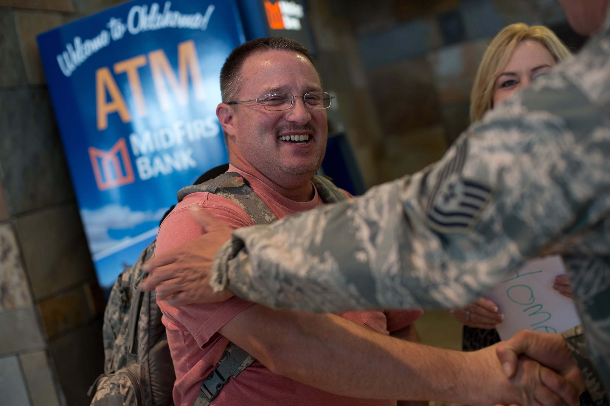 Senior Master Sgt. Jeffrey Woodall, 205th Engineering Installation Squadron unit project manager, reunites with his family at Will Rogers World Airport, Aug. 2, 2015, after returning from a six-month deployment to Southwest Asia. The 205 EIS was providing support for the enhancement of their Command and Control, Communications, Computers, Intelligence, Surveillance and Reconnaissance (C4ISR) capabilities. (Air National Guard photo by Senior Airman Tyler K. Woodward/Released)