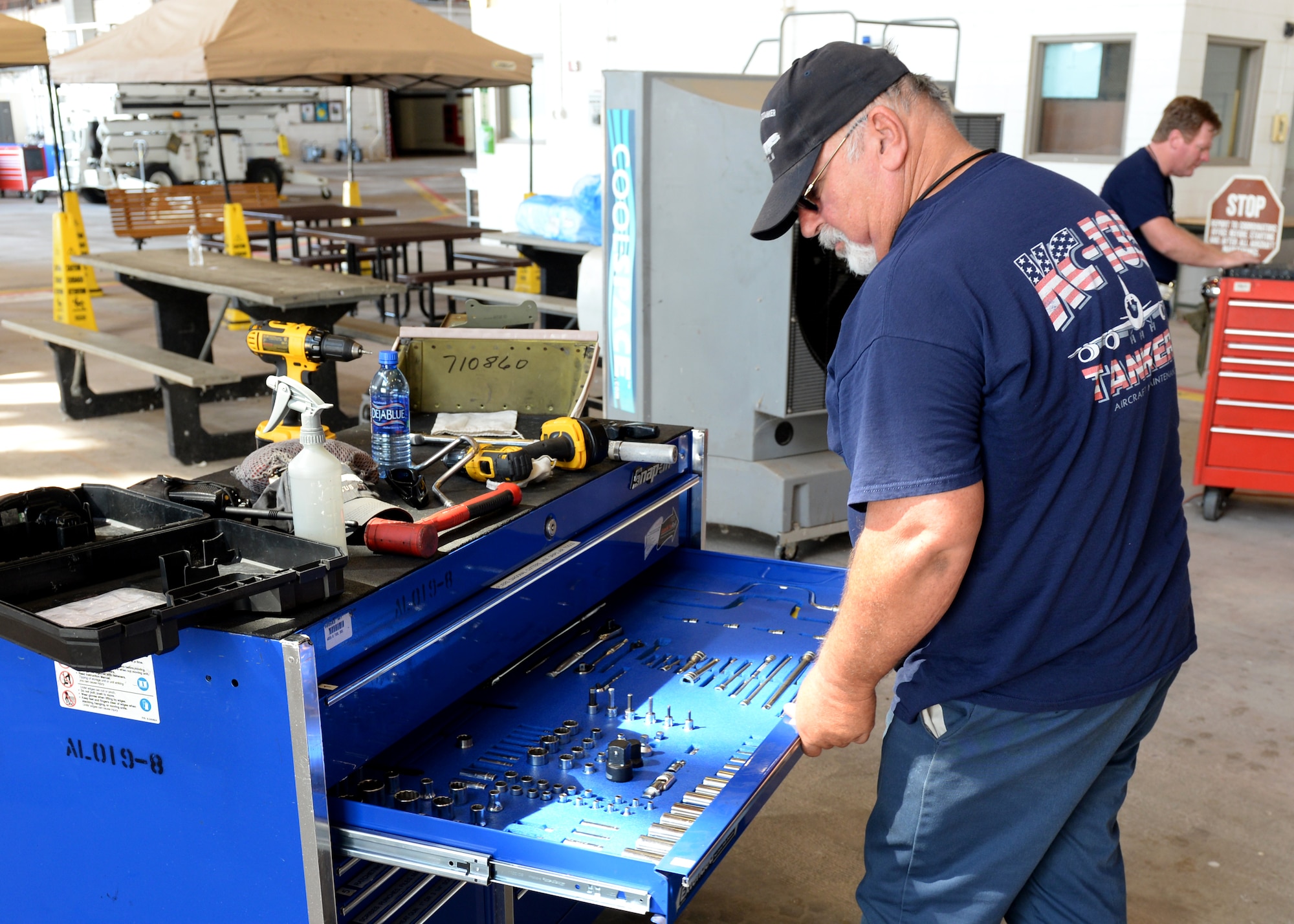 ALTUS AIR FORCE BASE, Okla. – Wiley Smith, KC-135 Stratotanker refueling aircraft flightline maintainer, grabs a tool in Hangar 285, July 28, 2015. The 97th Maintenance Directorate is made up of around 400 workers, mostly civilian maintainers. (U.S. Air Force photo by Airman 1st Class Kirby Turbak/Released)
