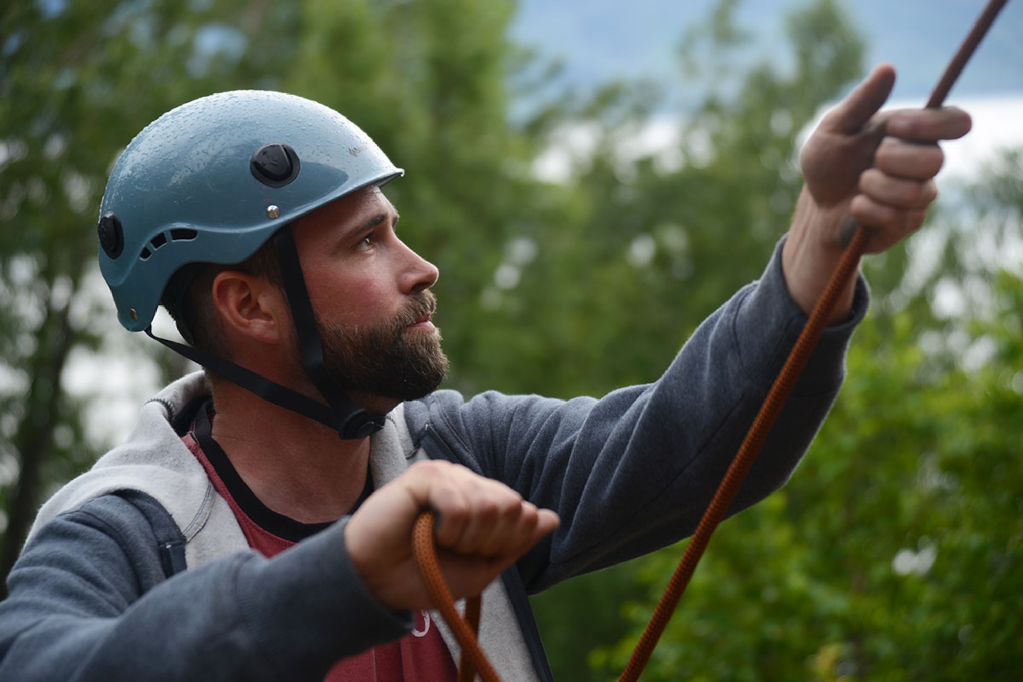 Guide Dave Mazur assists a climber on a difficult part of Boy Scout Rock in the McHugh Creek State Recreation Area of Chugach State Park July 9. Boy Scout Rock offers different climbing routes ranging from 15 to 30 feet in height. Mazur is assigned to the Joint Base Elmendorf-Richardson Outdoor Recreation Center. (U.S. Air Force photos/Airman Christopher R. Morales)