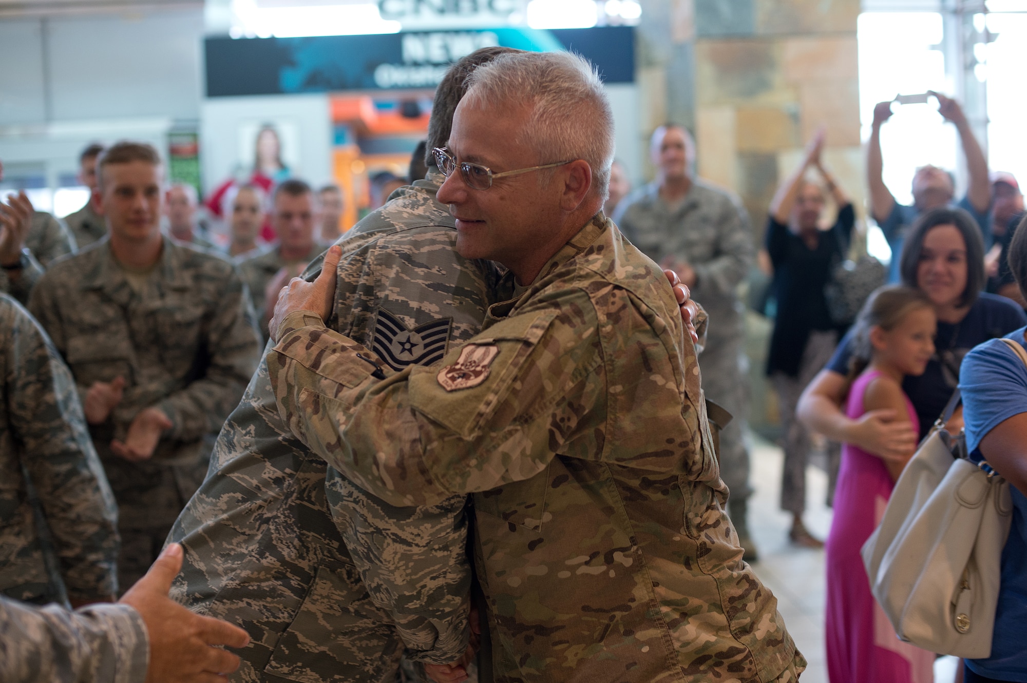 Master Sgt. Bryan Robinson, 205th Engineer Installation Squadron quality assurance NCO in charge, reunites with his family at Will Rogers World Airport, Aug. 2, 2015, after returning from a six-month deployment to Southwest Asia. The 205 EIS was providing support for the enhancement of their Command and Control, Communications, Computers, Intelligence, Surveillance and Reconnaissance (C4ISR) capabilities. (Air National Guard photo by Senior Airman Tyler K. Woodward/Released)