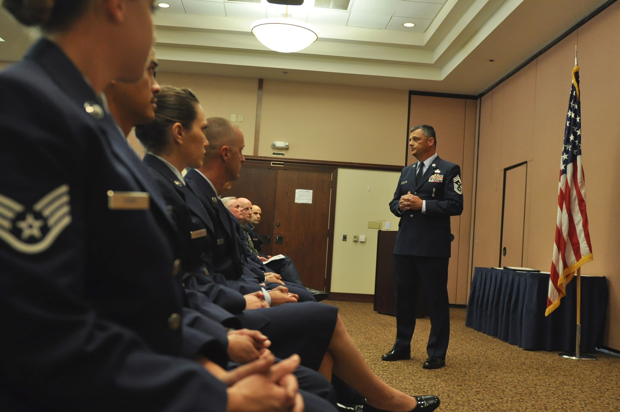 Chief Master Sgt. Denny Brown, 940th Wing command chief, speaks to newly inducted sergeants and master sergeants at an induction ceremony, Beale Air Force Base, Calif., Aug. 2, 2015. The Induction Ceremony is a military tradition that serves as a rite of passage for those advancing into the noncommissioned officer corps and senior noncommissioned officer corps. (U.S. Air Force photo by Tech. Sgt. Heather Skinkle/Released)
