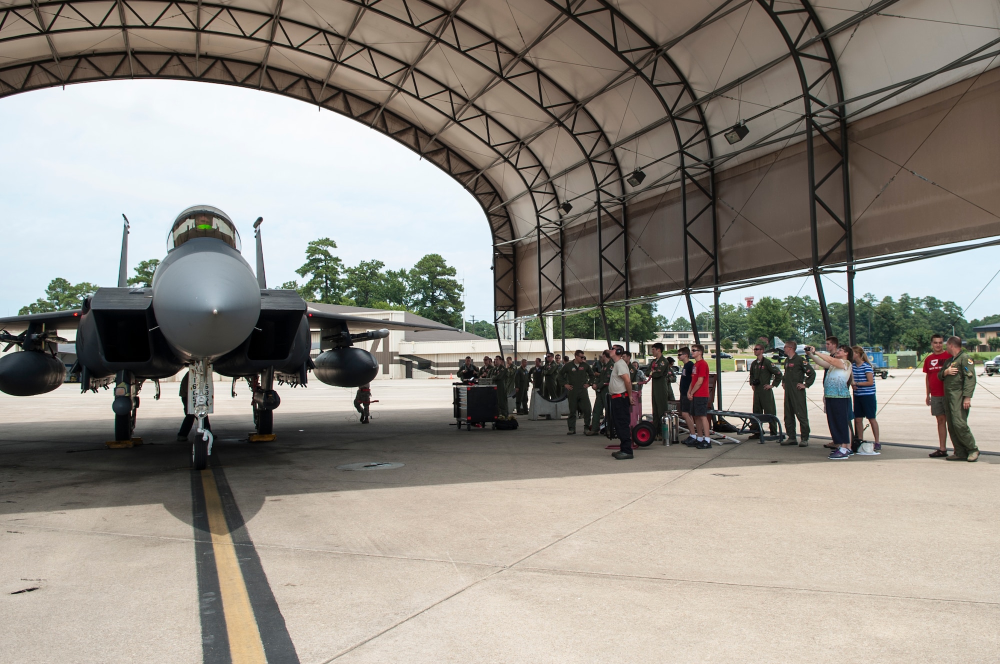Friends and family of Lt. Col. Paul Hibbard, 333rd Fighter Squadron instructor pilot, wait for Hibbard to disembark the jet after a training flight, July 22, 2015, at Seymour Johnson Air Force Base, North Carolina.  During the flight, Hibbard reached his 3,000th hour flying the F-15E Strike Eagle. (U.S. Air Force photo/Airman Shawna L. Keyes)
