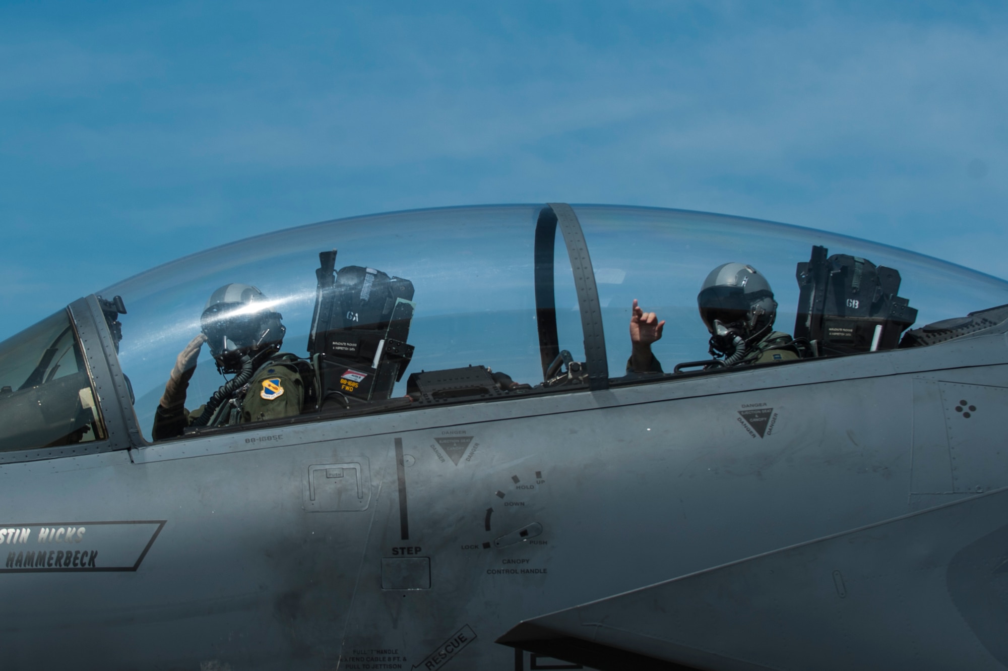 Lt. Col. Paul Hibbard (left), 333rd Fighter Squadron instructor pilot, and Capt. Justin Thompson, 333rd FS pilot, signal their crew chief as they taxi to the runway, July 22, 2015, at Seymour Johnson Air Force Base, North Carolina. After flying in operational squadrons for most of his career, Hibbard now instructs F-15E aircrew members on the intricacies of operating the Strike Eagle. (U.S. Air Force photo/Airman Shawna L. Keyes)
