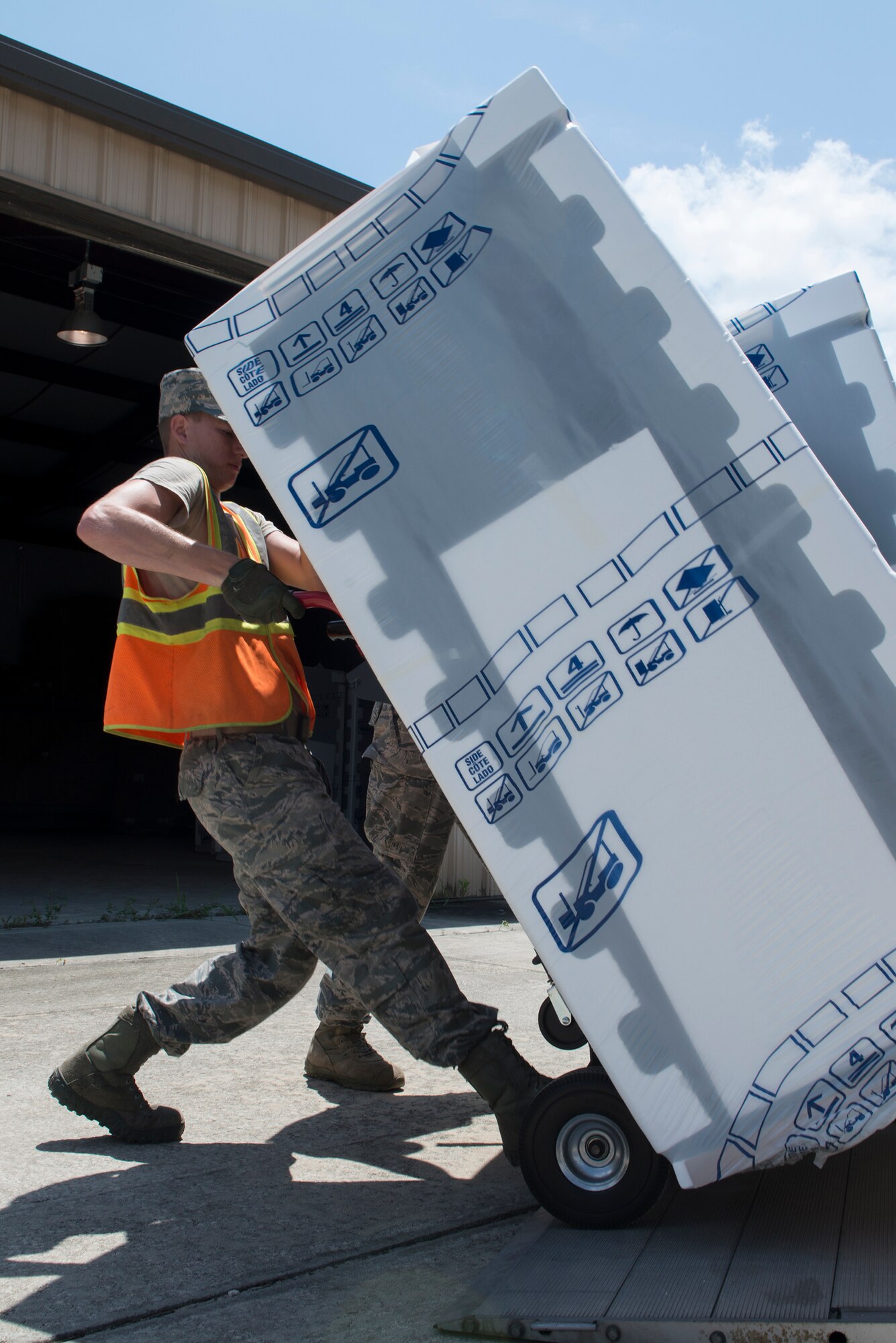 Airman 1st Class Matthew Melton, 23d Civil Engineer Squadron power production technician, unloads a refrigerator off a delivery truck Aug. 5, 2015, at Moody Air Force Base, Ga. Melton unloaded refrigerators as part of the Bay Orderly Program to maintain the dormitory building he lives in for a week. (U.S. Air Force photo by Airman 1st Class Kathleen D. Bryant/ Released)
