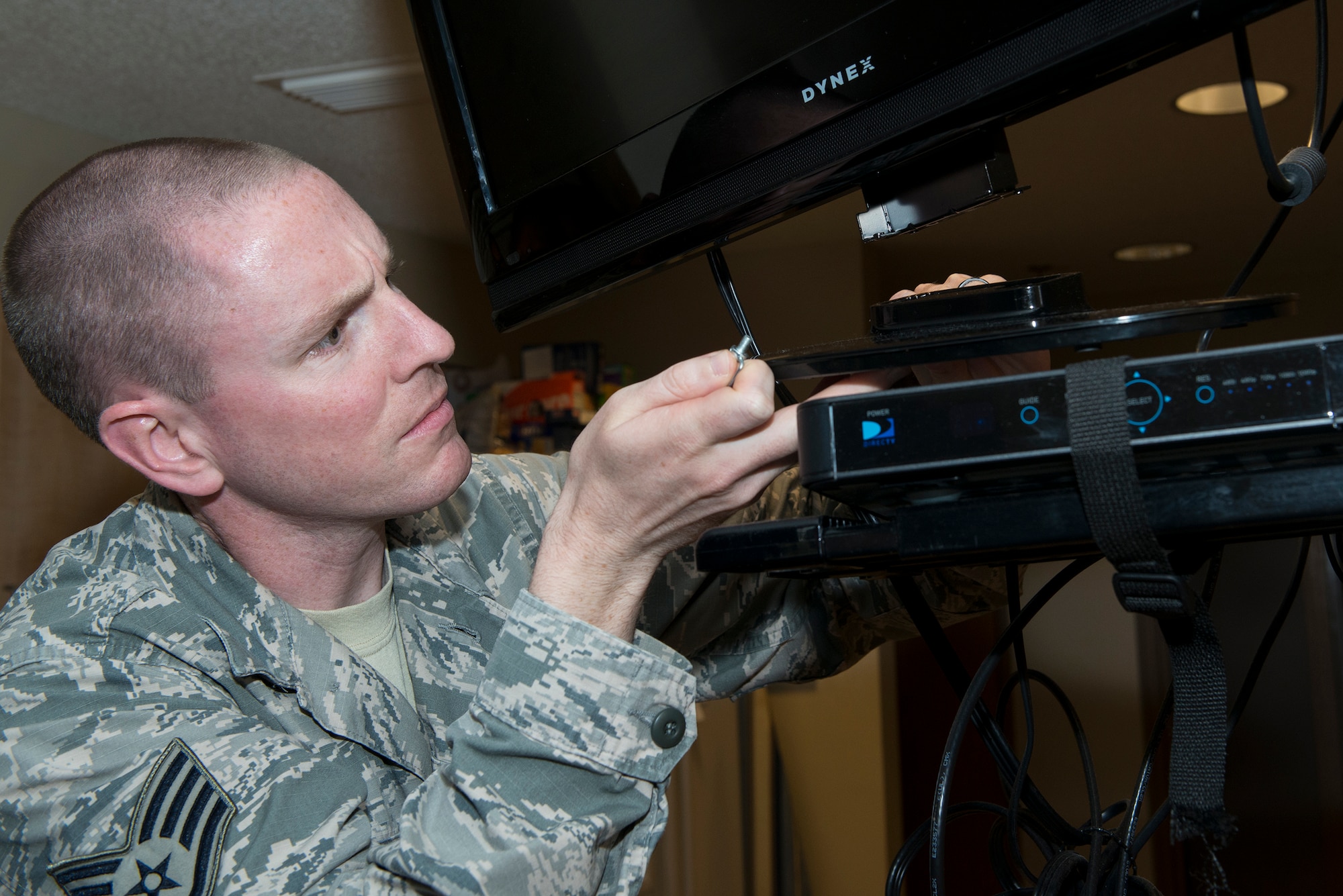 U.S. Air Force Staff Sgt. Nathan Hawley, 23d Civil Engineer Squadron airman dormitory leader, fixes a television during a maintenance check Aug. 5, 2015, at Moody Air Force Base, Ga. ADLs conduct individual monthly maintenance checks on all 13 dormitory facilities to sustain great quality of life for Airmen in the dorms. (U.S. Air Force photo by Airman 1st Class Kathleen D. Bryant/ Released)
