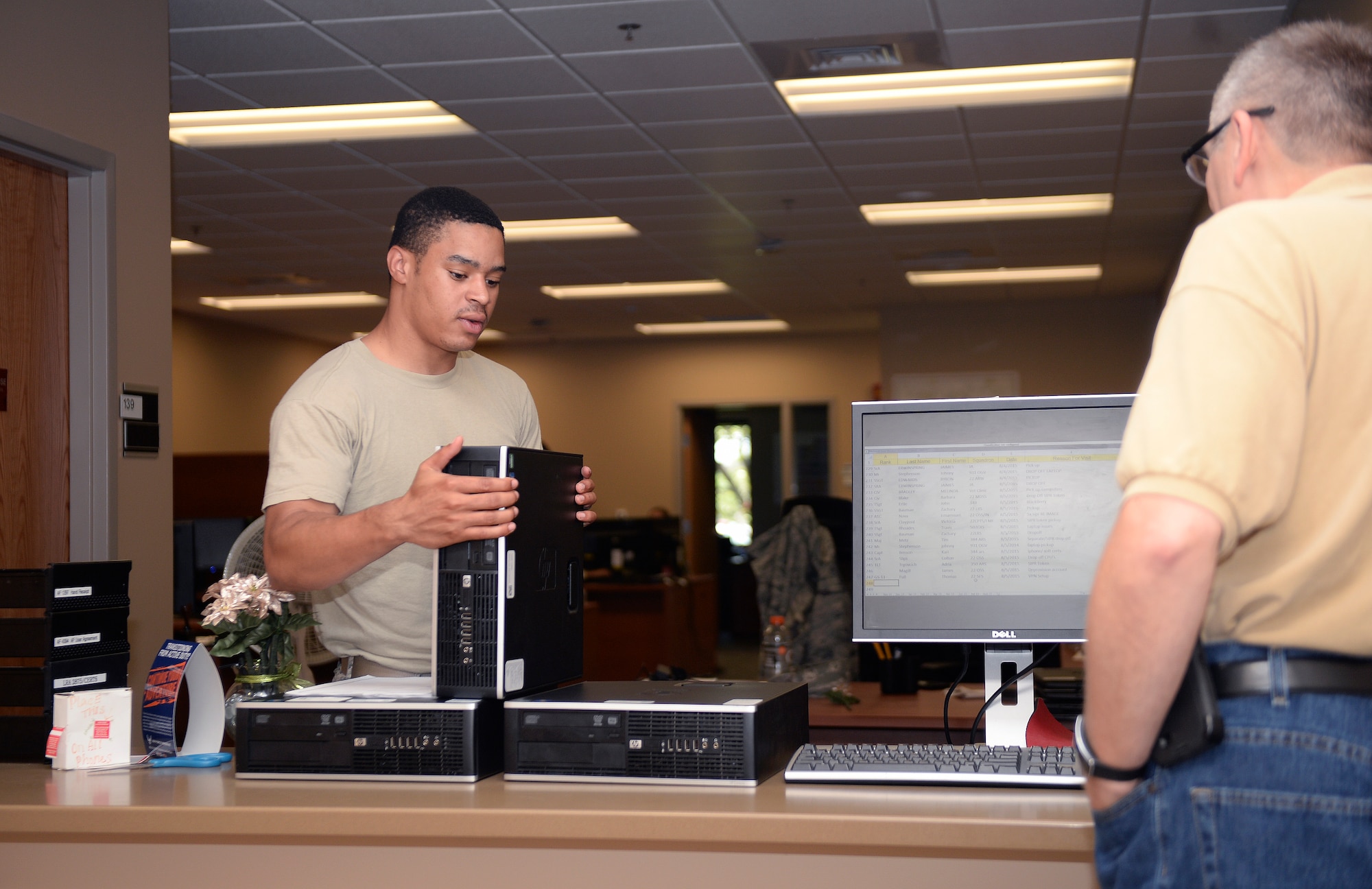 Senior Airman Kevin Green, 22nd Communications Squadron client systems technician, checks computer systems Aug. 5, 2015, at McConnell Air Force Base, Kan. One of the main duties of client systems technicians is to troubleshoot computers around base. (U.S. Air Force photo by Senior Airman Colby L. Hardin)