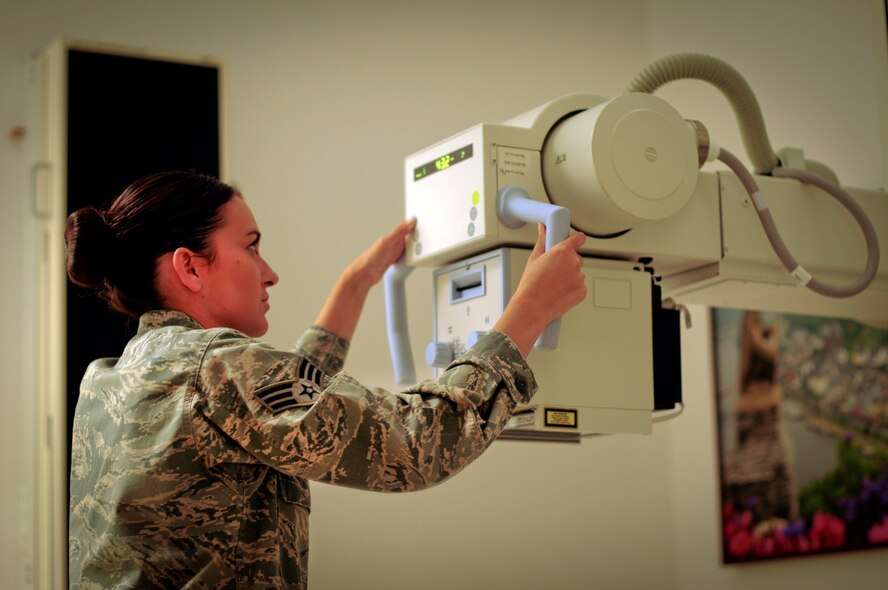 U.S. Air Force Senior Airman Michelle Kimball, a diagnostic imaging technician from the Virginia National Guard's 192nd Medical Squadron, adjusts her X-ray machine to the proper placement, Aug. 3, at the medical clinic on Spangdahlem Air Base, Germany. The guardsmen are working hand-in-hand with the active-duty force to sharpen their skills and ensure mission readiness. (U.S. Air National Guard photo by Senior Airman Shane S. Karp/Released)