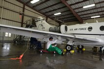 A 47th Flying Training Wing Maintenance Directorate maintainer cleans a T-1A Jayhawk on Laughlin Air Force Base, Texas, July 28, 2015. The T-1A Jayhawk is a medium-range, twin-engine jet trainer used in the advanced phase of specialized undergraduate pilot training for students selected to fly airlift or tanker aircraft. (U.S. Air Force photo by Airman 1st Class Ariel D. Partlow)(Released)