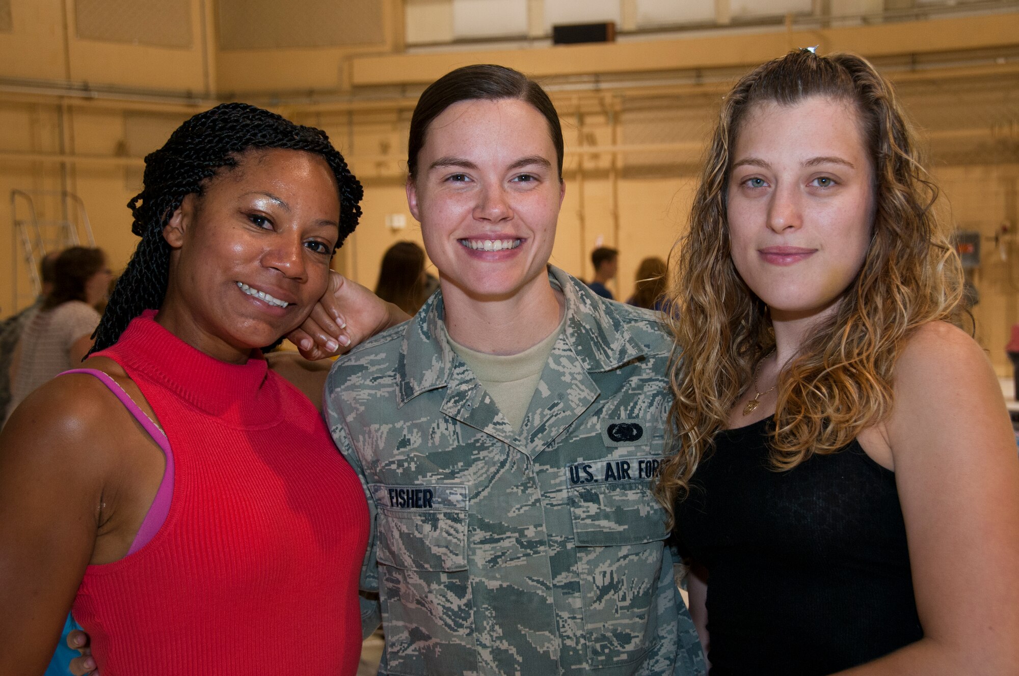 Staff Sgt. Megan Fisher, center, Supply Systems Analyst with the 108th Maintenance Squadron center, is welcomed home by her wife Erin, right and Staff Sgt. Stefany Jones, left,  at Joint Base McGuire-Dix-Lakehurst, N.J., August 5, 2015. More than 30 Airmen from the 108th Wing, New Jersey Air National Guard, returned home from a two-month deployment in support of Operations Freedom's Sentinel and Enduring Freedom in the Central Command area of operations. The Airmen were greeted by Brig. Gen. Michael L. Cunniff, the Adjutant General of New Jersey and Col. Robert A. Meyer Jr., Commander, 108th Wing and a group of more than 50 friends, family and Guard members. (U.S. Air National Guard photo by Master Sgt. Carl Clegg/Released)
