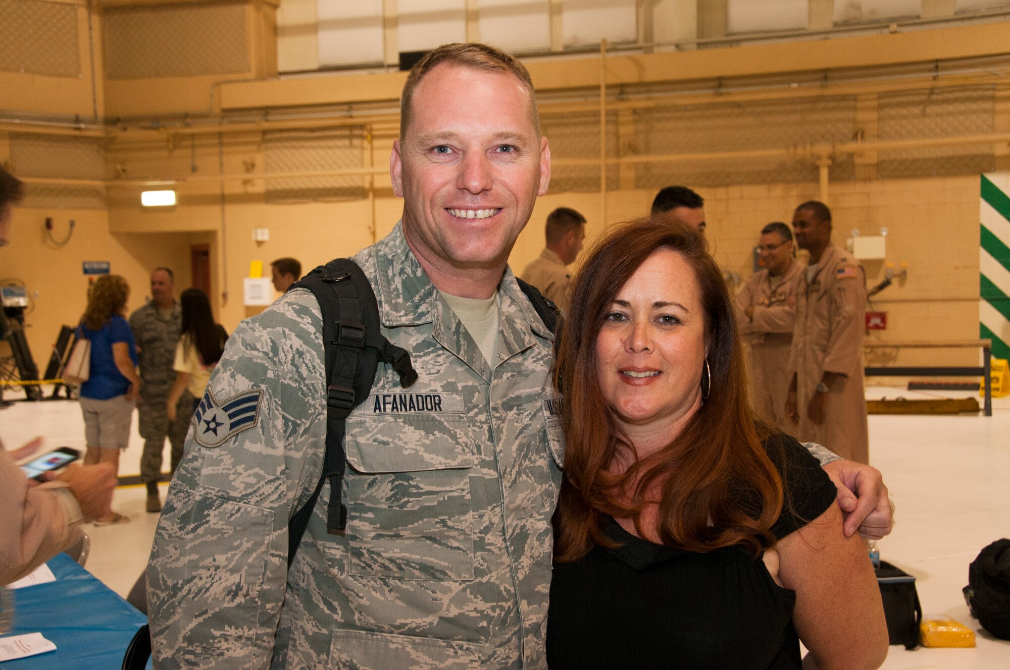 Senior Airman Jason Afanador, Fuel Specialist with the 108th Maintenance Squadron poses for a picture with his wife Colleen at Joint Base McGuire-Dix-Lakehurst, N.J., August 5, 2015. More than 30 Airmen from the 108th Wing, New Jersey Air National Guard, returned home from a two-month deployment in support of Operations Freedom's Sentinel and Enduring Freedom in the Central Command area of operations. The Airmen were greeted by Brig. Gen. Michael L. Cunniff, the Adjutant General of New Jersey and Col. Robert A. Meyer Jr., Commander, 108th Wing and a group of more than 50 friends, family and Guard members. (U.S. Air National Guard photo by Master Sgt. Carl Clegg/Released)