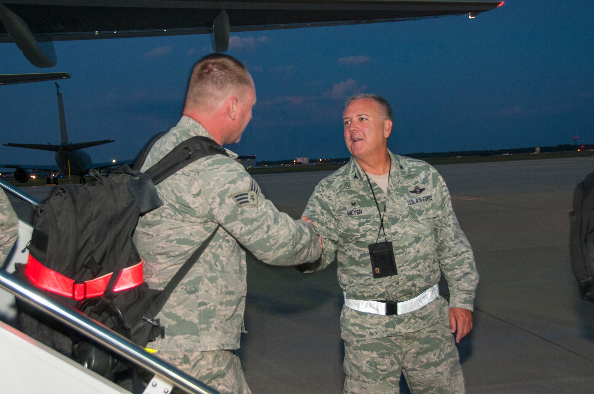Senior Airman Jason Afanador, left, Fuel Specialist with the 108th Maintenance Squadron is greeted by Col. Robert A. Meyer Jr., right, Commander, 108th Wing at Joint Base McGuire-Dix-Lakehurst, N.J., August 5, 2015. More than 30 Airmen from the 108th Wing, New Jersey Air National Guard, returned home from a two-month deployment in support of Operations Freedom's Sentinel and Enduring Freedom in the Central Command area of operations. The Airmen were greeted by Brig. Gen. Michael L. Cunniff, the Adjutant General of New Jersey and Col. Robert A. Meyer Jr., Commander, 108th Wing and a group of more than 50 friends, family and Guard members. (U.S. Air National Guard photo by Master Sgt. Carl Clegg/Released)