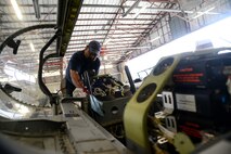 Jacob Leos, 47th Flying Training Wing Maintenance Directorate maintainer, works on a T-6A Texans II on Laughlin Air Force Base, Texas, July 28, 2015.The T-6A Texan II is a single-engine, two-seat primary trainer designed to train student pilots. (U.S. Air Force photo by Airman 1st Class Ariel D. Partlow)(Released)