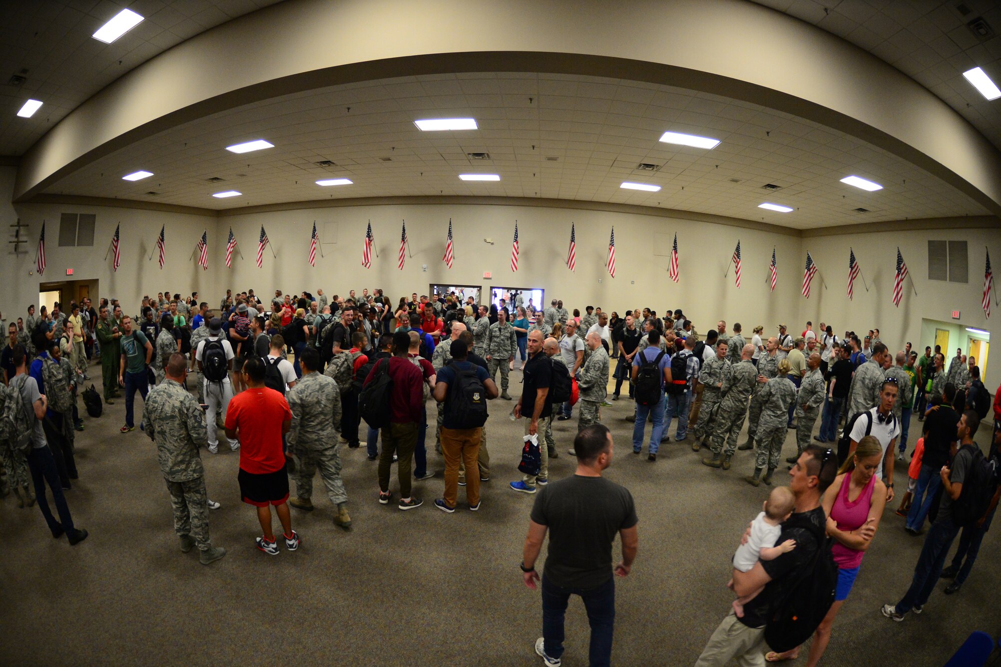 Spouses, children, friends and co-workers welcome home Airmen returning to Barksdale Air Force Base, La., Aug. 4, 2015, from a routine training exercise. Routine training exercises are good ways for Airmen to test and hone their skills so they can provide unmatched expeditionary combat anytime, anywhere. (U.S. Air Force photo/Airman 1st Class Luke Hill)
