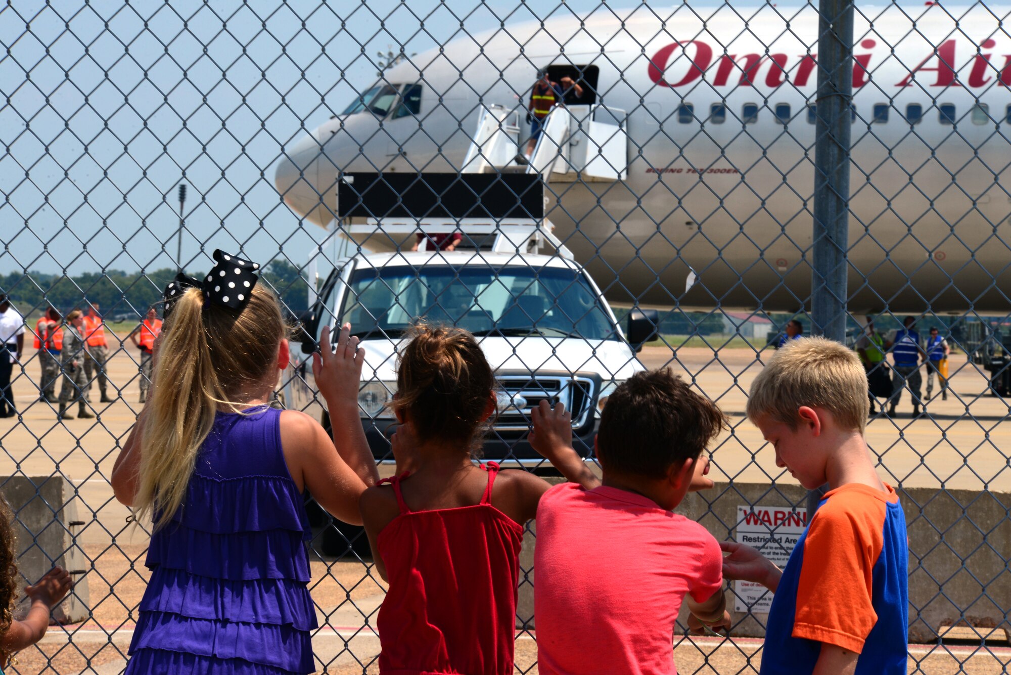 Children wait to be reunited with family returning to Barksdale Air Force Base, La., Aug. 4, 2015, from a routine training exercise. Training missions like these ensure the 2nd Bomb Wing remains second to none. (U.S. Air Force photo/Airman 1st Class Luke Hill)