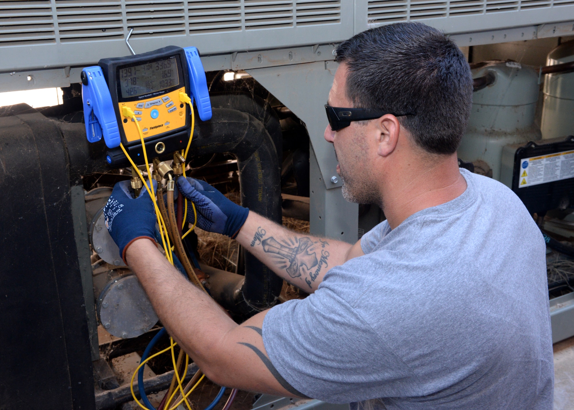 ALTUS AIR FORCE BASE, Okla. – Matt McKee, 97th Civil Engineer Squadron heating, ventilation and air conditioning technician, uses a digital gauge to check the status of a chiller located at Building 228, Aug. 5. The Altus AFB HVAC shop is responsible for regulating the temperature throughout all base facilities, maintaining workable and livable environments and ensuring mission success. (U.S. Air Force photo by Airman 1st Class Megan E. Acs/Released)