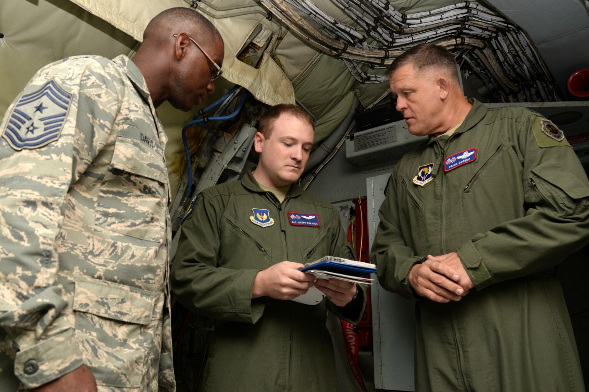 U.S Air Force Airman 1st Class Joseph Wukasch, center, 351st Air Refueling Squadron boom operator from Austin, Texas, briefs U.S. Air Force Gen. Frank Gorenc, right, U.S. Air Forces in Europe and Air Forces in Africa commander, and U.S. Air Force Chief Master Sgt. James Davis, USAFE-AFAFRICA command chief, on KC-135 Stratotanker safety measures Aug. 5, 2015, on RAF Mildenhall, England. The flight was the beginning of an immersion tour for the two leaders before seeing the rest of Team 