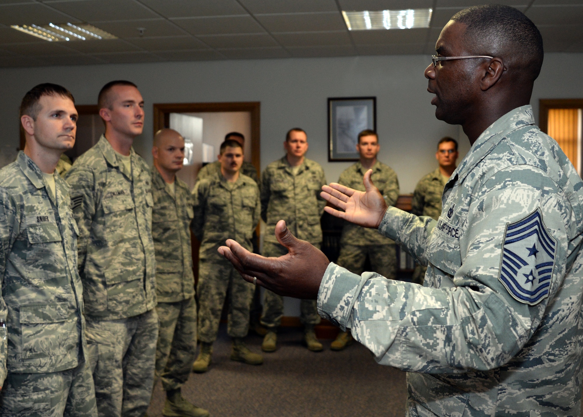 U.S. Air Force Chief Master Sgt. James Davis, right, U.S. Air Forces in Europe and Air Forces in Africa command chief, addresses members of the 100th Operation Group Aug. 5, 2015, on RAF Mildenhall, England. Davis and U.S. Air Force Gen. Frank Gorenc, USAFE-AFAFRICA commander, visited several facilities and a variety of Airmen for a better understanding of Team Mildenhall and its mission. (U.S. Air Force photo by Tech. Sgt. Krystie Martinez/Released)