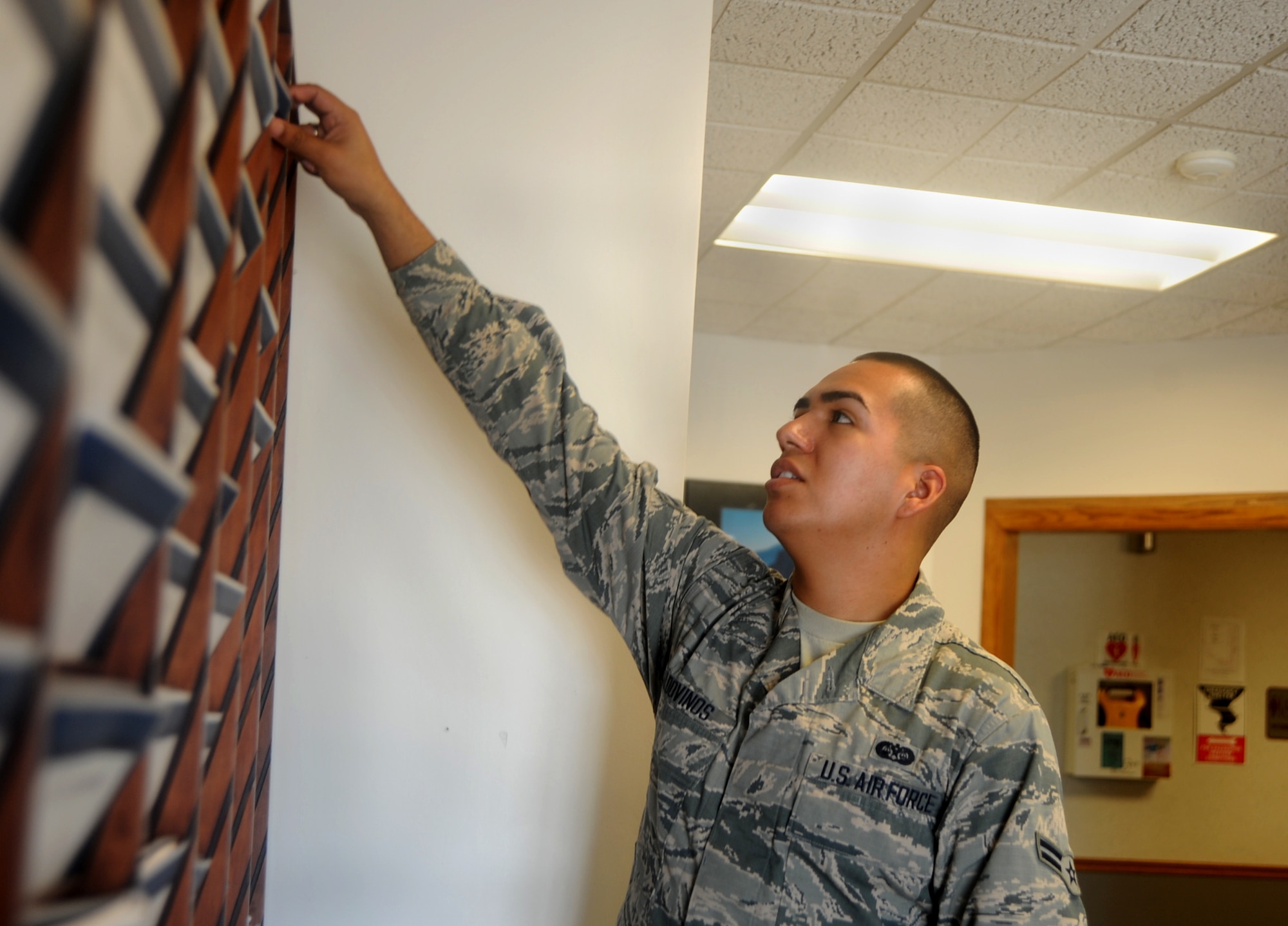 Airman 1st Class Maurico Valdovinos, 22nd Air Refueling Wing Judge Advocate paralegal, ensures the Legal Self-Help Center is fully stocked, Aug. 5, 2015, at McConnell Air Force Base, Kan. The self-help center provides hand-outs on a variety of personal civil legal issues to include adoption, domestic relationships, military clauses and information about service member federal relief act. (U.S. Air Force photo by Staff Sgt. Rachel Waller)