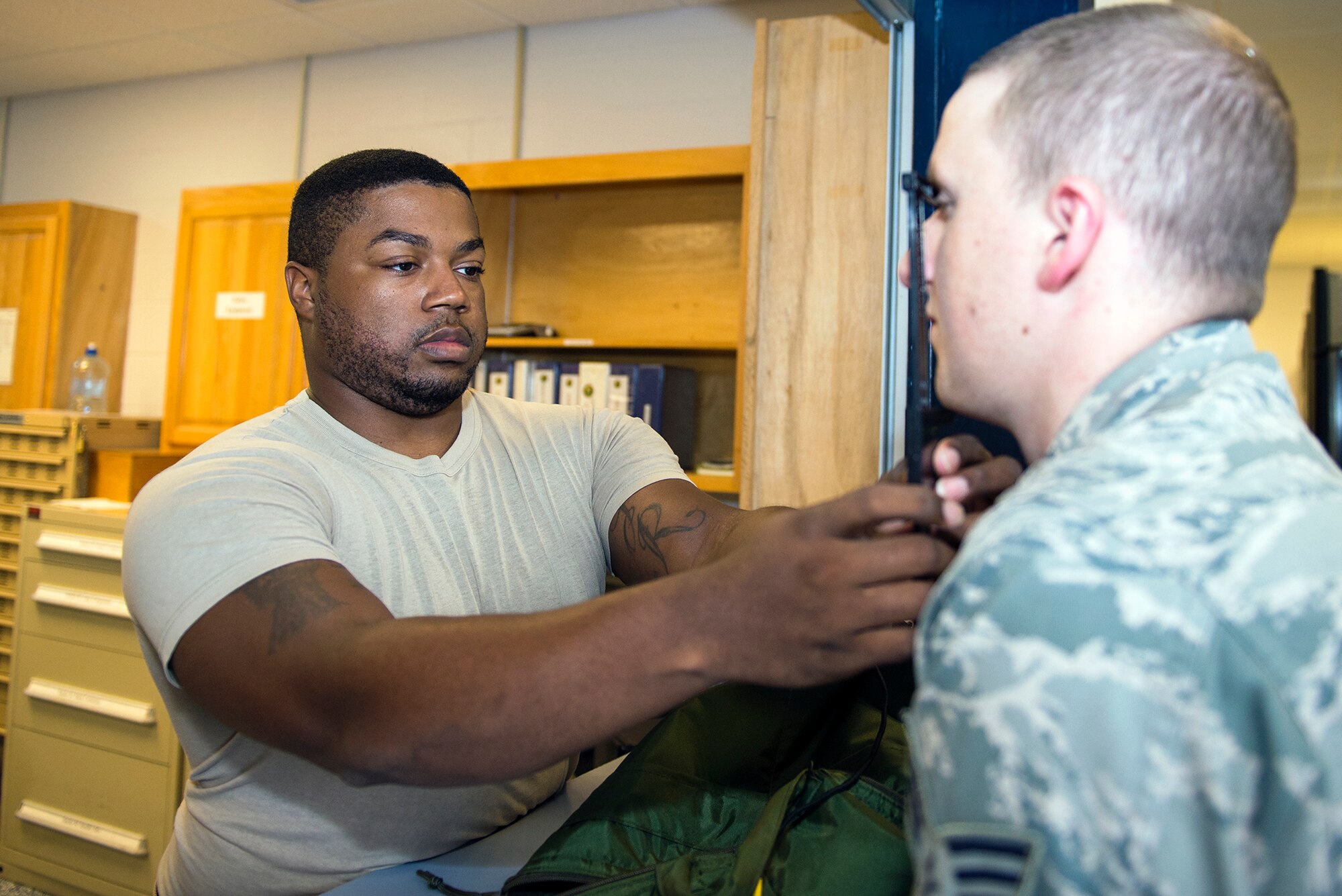 U.S. Air Force Staff Sgt. Brandon Abercrombie, 347th Operations Squadron aircrew flight equipment assistant NCO in charge, sizes facial measurements for Senior Airman Charles Huber, 71st  Rescue Squadron loadmaster, for his HGU-55/P helmet Aug. 5, 2015, at Moody Air Force Base, Ga. The 71st RSQ HC-130P/J aircrew members are required to get fitted for new helmet gear once a year. (U.S. Air Force photo by Airman Greg Nash/Released)