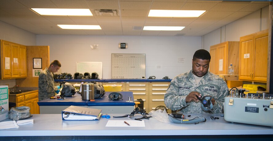 Aircrew flight equipment technicians from the 347th Operations Support Squadron prepare and inspect HGU-55/P helmets Aug. 5, 2015, at Moody Air Force Base, Ga. Members from the 347th OSS AFE are responsible for supporting the 71st Rescue Squadron’s HC-130 P/J aircrew members with flight gear such as helmets and night vision goggles. (U.S. Air Force photo by Airman Greg Nash/Released) 