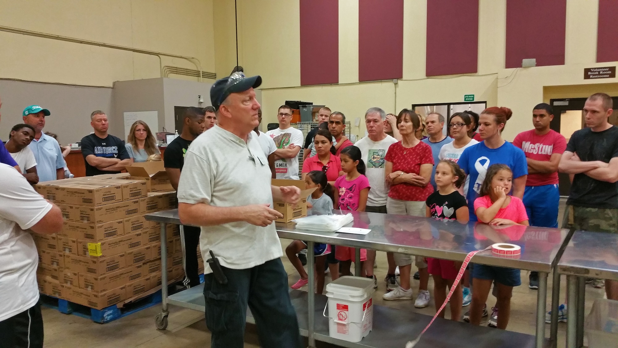 Harry Steen, St. Louis Area Foodbank Repackaging Coordinator, explains to volunteers that include nearly two dozen from Scott Air Force Base, Ill., how to package the food, Bridgeton, Mo., July 25, 2015. The volunteers processed 14,670 pounds worth of food to be sent out to local food banks in 26 Illinois and Missouri counties this distribution center covers. (U.S. Air Force photo by Airman 1st Class Erica Holbert-Siebert)