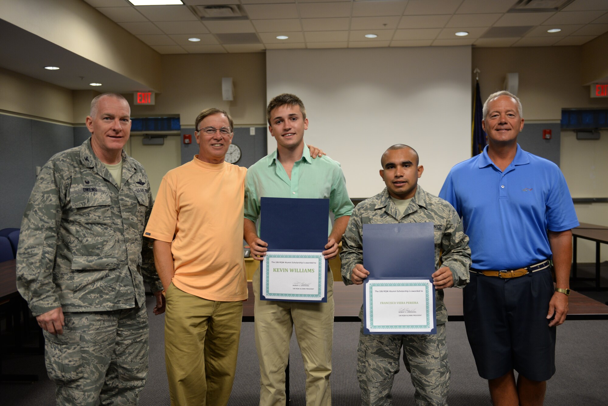 WESTHAMPTON BEACH, NY - Col Thomas J Owens and Col Robert Landsiedel (retired) awards Senior Airman Francisco Vierapereira, of the 106th Civil Engineering Squadron and Kevin William, son of MSgt (Ret.) Don Williams the Alumni Association Scholarship at FS Gabreski ANG on August 05, 2015.
