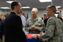 Lt. Gen. John Thompson, Air Force Life Cycle Management Center commander, and Maj. Gen. Craig Olson, C3I and Networks program executive officer, speak with Charlie Benway, Air Force Materiel Command Community Liaison Program member, during a community leader breakfast at Hanscom Air Force Base, Mass., Aug. 5, 2015. Thompson hosted the event for congressional, state and local leaders to express appreciation for their support and provide a forum for further relationship building. (U.S. Air Force photo by Linda LaBonte Britt)
