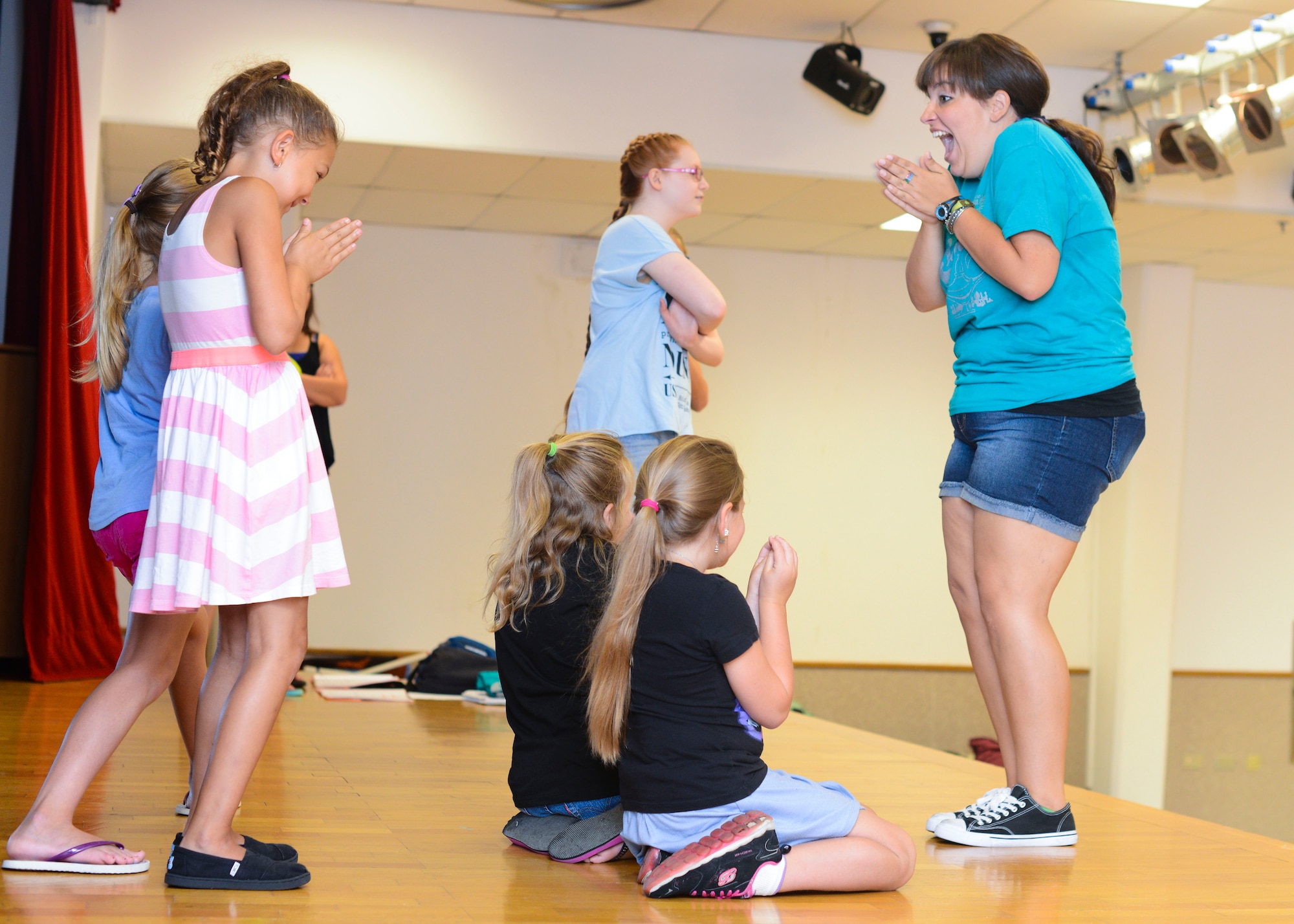 Rachel Bailey, Missoula Children’s Theatre director, teaches stage movements to children during an “Aladdin” musical rehearsal, Aug. 4, 2015, at Aviano Air Base, Italy. The children will practice every day until show time at 5 p.m. on Aug. 8 in the community center on Area 1. (U.S. Air Force photo by Senior Airman Austin Harvill/Released)