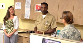 CMDCM(SS/AW) Michael Jackson, Navy Region Southeast, (center) visited the Joint Base Charleston, SC Emergency Operations Center on August 4, 2015. Master Chief Jackson listens to comments from the EOC staff.