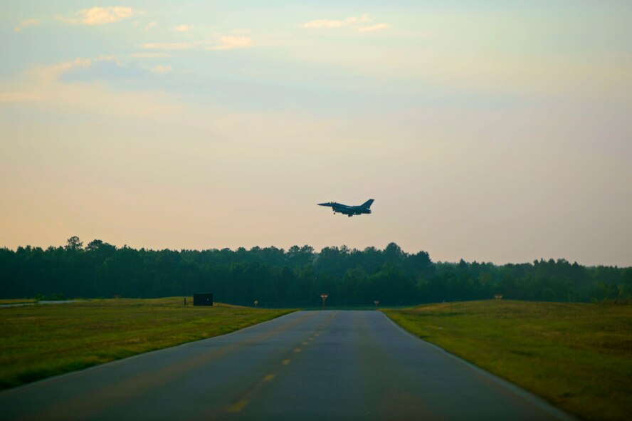 An F-16CM Fighting Falcon approaches a runway as it prepares for landing at Shaw Air Force Base, S.C., July 31, 2015. The 20th Fighter Wing pilots were participating in night flying, a series of training flights that better prepare them for nighttime combat operations. (U.S. Air Force photo by Senior Airman Jensen Stidham/Released) 