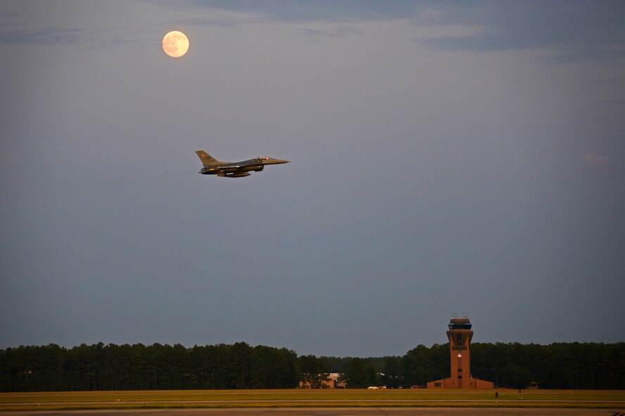 An F-16CM Fighting Falcon assigned to the 20th Fighter Wing flies over the runway at Shaw Air Force Base, S.C., July 31, 2015. The 20th Fighter Wing pilots flew night sorties to practice using night vision equipment and perform tactics that are critical to survivability during combat situations. (U.S. Air Force photo by Senior Airman Jensen Stidham/Released) 