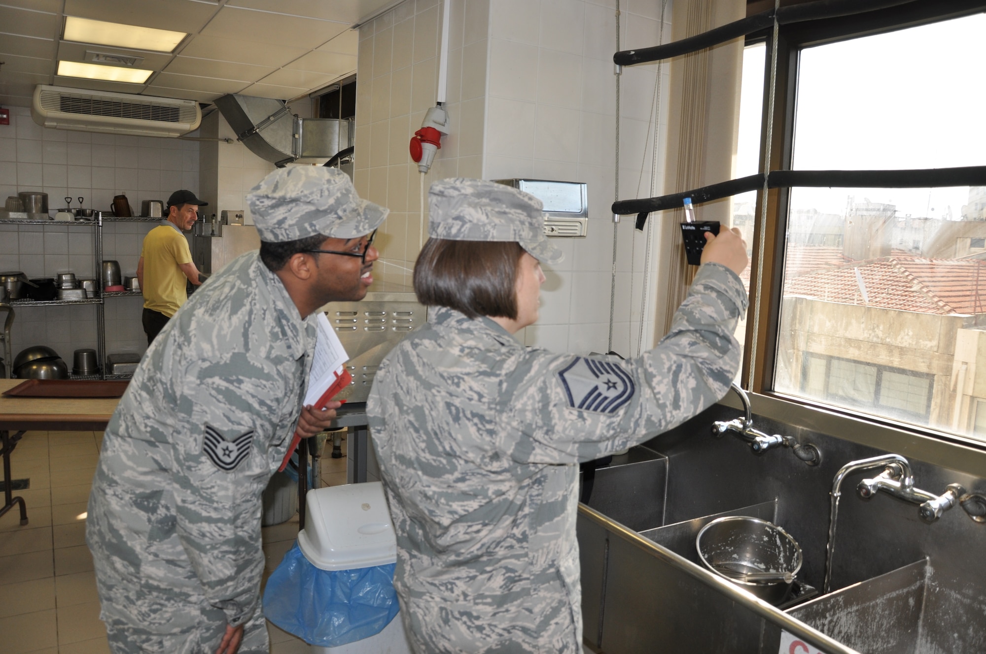 Master Sgt. Tanya Jacquez, 425th Air Base Squadron Medical Aid Station flight chief, and Tech. Sgt. Robert Wilson, 425th ABS Medical Aid Station NCO in charge, test water for chlorine levels in the Izmir Club water. (U.S. Air Force photo by Tanju Varlikli)
