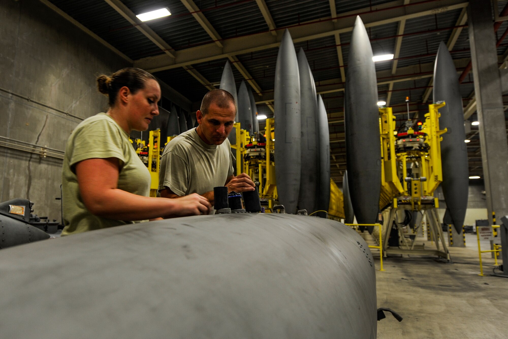 U.S. Air Force Staff Sgt. Thomas Lewellen, 18th Component Maintenance Squadron aircraft fuel systems craftsman, and U.S. Air Force Senior Airman Elizabeth Melton, 18th CMS fuel systems journeyman, inspect an external fuel tank on Kadena Air Base, Japan, Aug. 4, 2015. Lewellen is Melton’s supervisor and strives to help her progress with her Air Force career. (U.S. Air Force photo by Airman 1st Class Lynette Rolen)