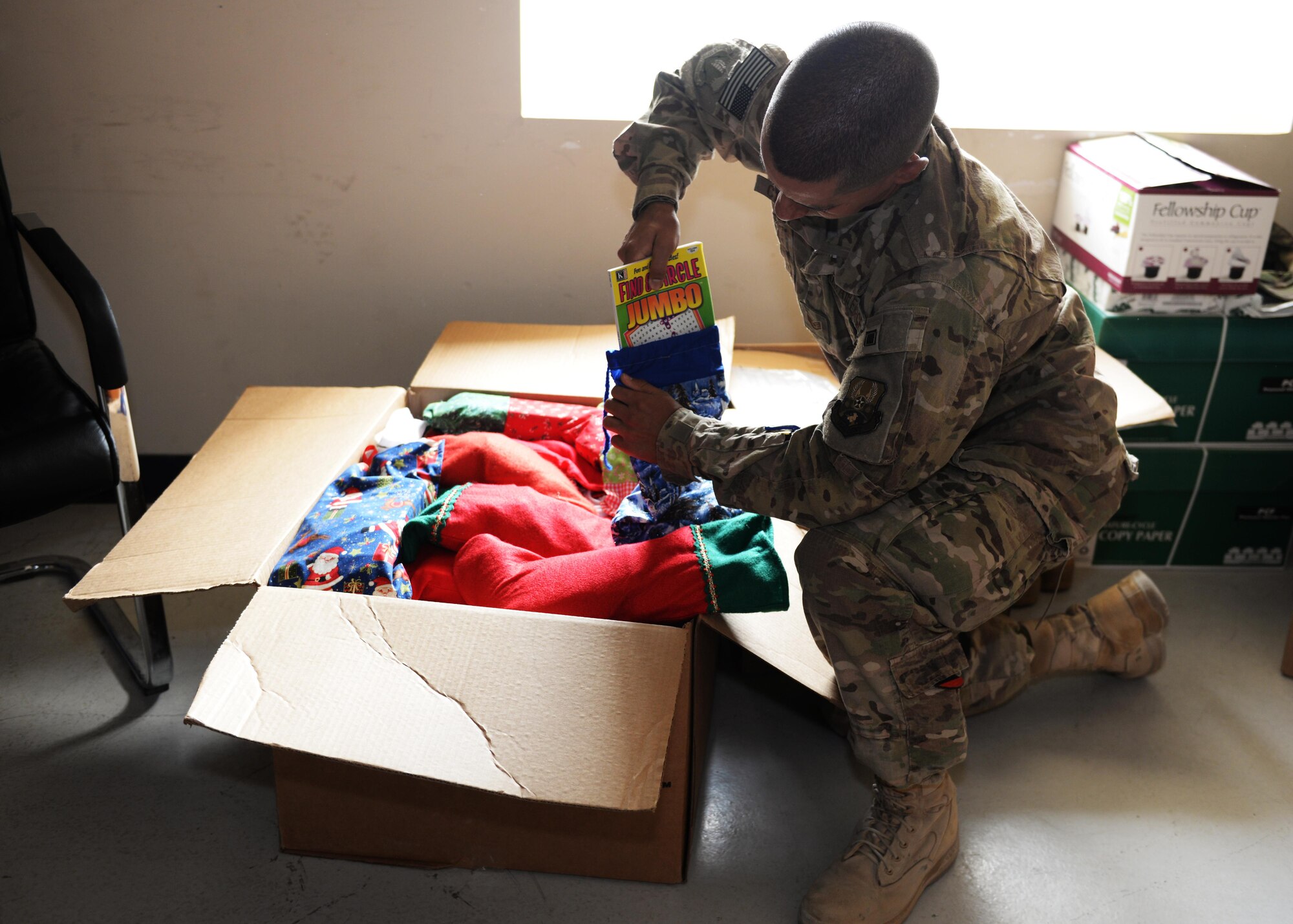 U.S. Air Force Staff Sgt. Anthony Camper, 455th Air Expeditionary Wing chaplain assistant, packs goodies to send to Airmen at surrounding forward operating bases, Aug. 6, 2015, at Bagram Airfield, Afghanistan. As a chaplain assistant, Camper acts as a mentor and provides counseling to BAF Airmen as well as Airmen in surrounding FOBs throughout the AOR, ensuring units maintain morale and remain spiritually and mentally fit to complete the mission. (U.S. Air Force photo by Senior Airman Cierra Presentado/Released)