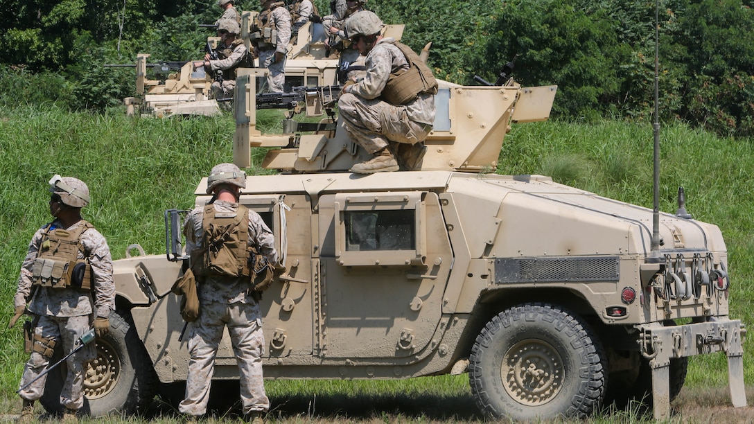 Marines with Support Company, 2nd Combat Engineer Battalion, fire M240B Machine Guns and M2 Browning .50-Caliber Machine Guns at targets of an unknown distance from the turrets of armored Humvees as part of a convoy live-fire range at Fort A.P. Hill, Virginia, Aug. 4, 2015. The company conducted the five-vehicle convoy in order to increase their proficiency with the weapons systems and to improve their communication skills. 