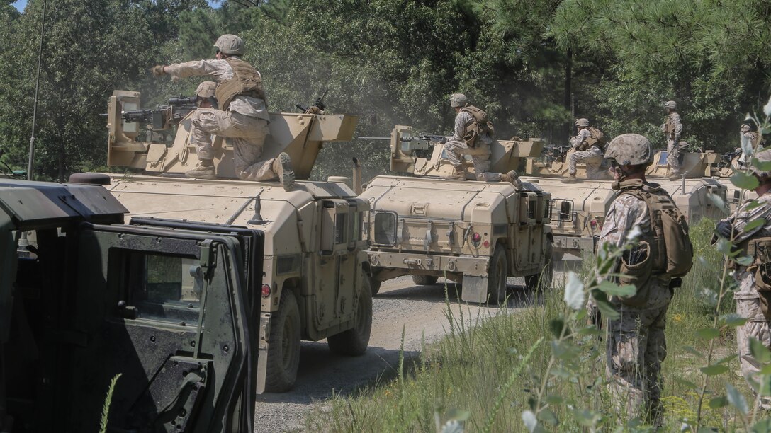 Marines with Support Company, 2nd Combat Engineer Battalion, fire M240B Machine Guns and M2 Browning .50-Caliber Machine Guns at targets of an unknown distance from the turrets of armored Humvees as part of a convoy live-fire range at Fort A.P. Hill, Virginia., Aug. 4, 2015. The company conducted the five vehicle convoy in order to increase their proficiency with the weapons systems and to improve their communication skills. 