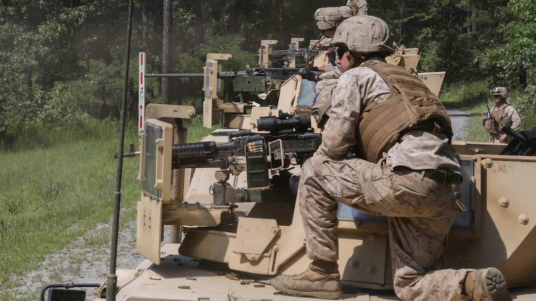 Marines with Support Company, 2nd Combat Engineer Battalion, fire M240B Machine Guns and M2 Browning .50-Caliber Machine Guns at targets of an unknown distance from the turrets of armored Humvees as part of a convoy live-fire range at Fort A.P. Hill, Virginia, Aug. 4, 2015. The company conducted the five vehicle convoy in order to increase their proficiency with the weapons systems and to improve their communication skills. 