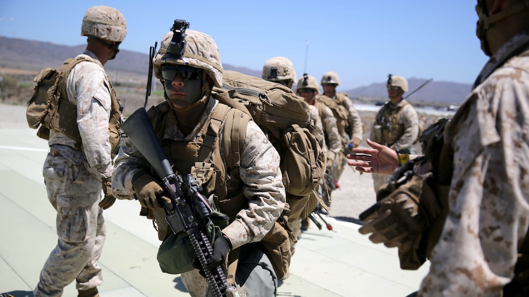 Marines with 3rd Battalion, 5th Marine Regiment, 1st Marine Division run into position prior to boarding a CH-53E Super Stallion before conducting a helicopter raid, as part of the Marine Corps Combat Readiness Evaluation (MCCRE), aboard Marine Corps Base Camp Pendleton, California, Aug. 4, 2015. The MCCRE is used evaluate the operational readiness of a designated unit.