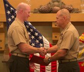Lt. Gen. Robert Neller (right), commander of U. S. Marine Corps Forces Command, awards Col. Paul Ryan with the Legion of Merit during the retirement ceremony for Col. Ryan at Sewell’s Point Golf Course, Norfolk, Va., July 17, 2015. Col. Ryan retires after 30 years of service, most recently as the commanding officer of Headquarters and Service Battalion, U. S. Marine Corps Forces Command.