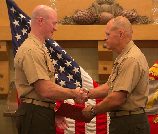 Lt. Gen. Robert Neller (right), commander of U. S. Marine Corps Forces Command, awards Col. Paul Ryan with the Legion of Merit during the retirement ceremony for Col. Ryan at Sewell’s Point Golf Course, Norfolk, Va., July 17, 2015. Col. Ryan retires after 30 years of service, most recently as the commanding officer of Headquarters and Service Battalion, U. S. Marine Corps Forces Command.
