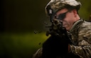 Airman 1st Class Seth Lamb, a member of the 122nd Security Forces Squadron, fires a burst of blanks from his M249 light machine gun at enemy combatants during an ambush exercise July 29, 2015, at the Combat Readiness Training Center in Alpena, Mich. Airmen from the 122nd Fighter Wing participated in the exercise as part of their annual training. (U.S. Air National Guard photo/Staff Sgt. William Hopper)