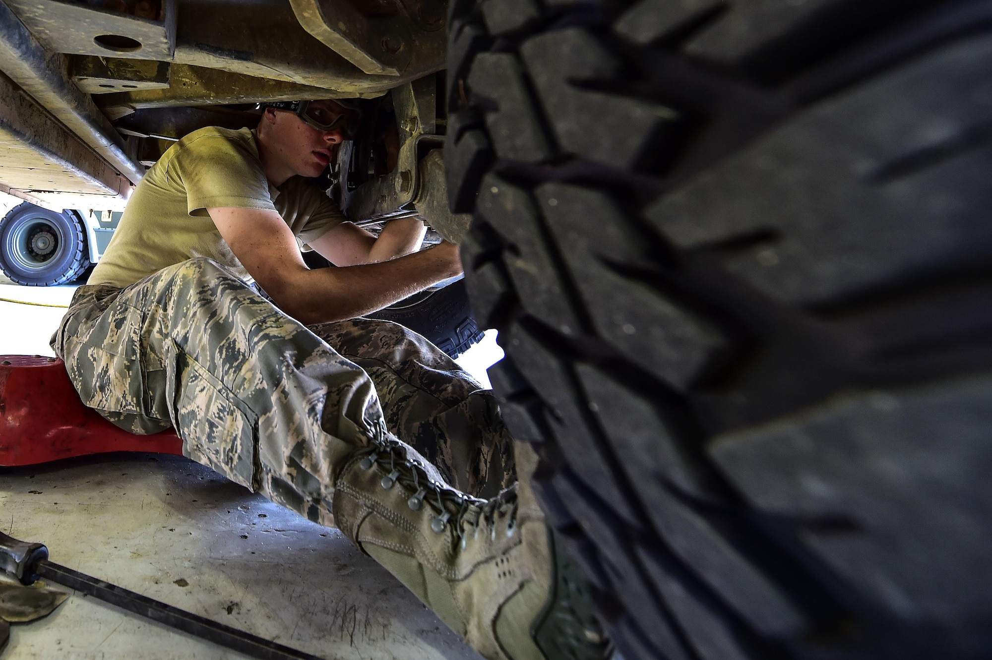 Airman 1st Class Joseph Caldwell, 1st Special Operations Logistics Readiness Squadron vehicle mechanic apprentice, performs scheduled routine maintenance on a Humvee on Hurlburt Field, Fla., Aug. 3, 2015. The vehicle maintenance flight maintains base vehicles including Humvees, fire trucks and K-loaders used for training and flight line operations. (U.S. Air Force photo/Senior Airman Jeff Parkinson)