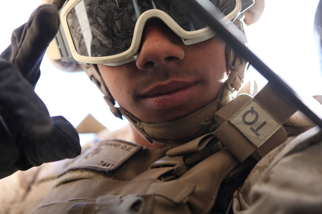 Lance Cpl. Oscar Bernard, a motor vehicle operator with 1st Transportation Support Battalion, Combat Logistics Regiment 1, looks towards his convoy commander to confirm target location while providing security during a vehicle recovery mission as part of Integrated Training Exercise aboard Marine Corps Air Ground Combat Center Twentynine Palms, Calif., Aug. 4, 2015. The exercise allowed the Marines to train in a live fire environment and hone their tactical training procedures.
