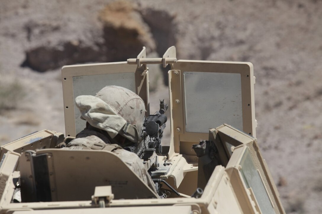 Lance Cpl. Oscar Bernard, a motor vehicle operator with 1st Transportation Support Battalion, Combat Logistics Regiment 1, prepares to engage simulated enemy targets during a vehicle recovery mission as part of Integrated Training Exercise aboard Marine Corps Air Ground Combat Center Twentynine Palms, Calif., Aug. 4, 2015. The exercise gave the Marines with 1st TSB a chance to train in a unique and stressful environment to simulated scenarios.