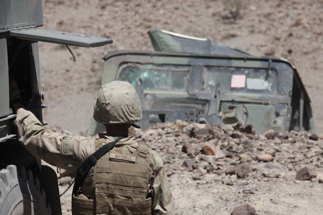 Corporal Trey Mitchell, a motor vehicle operator with 1st Transportation Support Battalion, Combat Logistics Regiment 1, uses a wrecker to pull a downed Humvee out of a ditch during a vehicle recovery mission as part of Integrated Training Exercise aboard Marine Corps Air Ground Combat Center Twentynine Palms, Calif., Aug. 4, 2015. While the main mission was to recover the downed vehicle, the training also allowed the Marines to engage targets as part of a live-fire exercise.