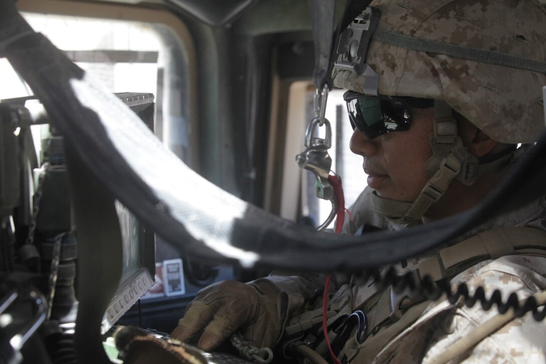 First Lt. Gary Raymundo, a convoy commander with 1st Transportation Support Battalion, Combat Logistics Regiment 1, communicates with the command operations center during a vehicle recovery mission as part of Integration Training Exercise aboard Marine Corps Air Ground Combat Center Twentynine Palms, Calif., Aug. 4, 2015. The exercise allowed the Marines to train in a live fire environment and hone their tactical training procedures.