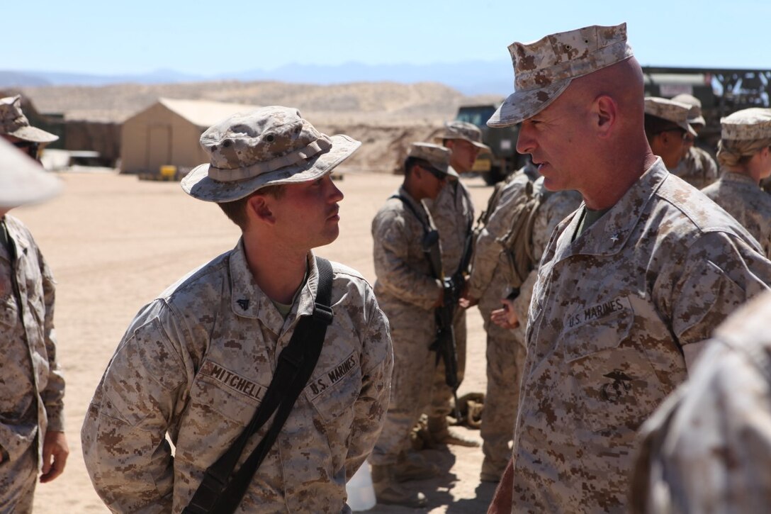 Brigadier Gen. David Ottignon, the commanding general of 1st Marine Logistics Group, speaks to Lance Cpl. Trey Mitchell, a motor transportation vehicle operator with Transportation Support Battalion 1, Combat Logistics Regiment 1, while visiting his Marines during Integrated Training Exercise at Forward Operating Base 3 aboard Marine Corps Ground Air Combat Center Twentynine Palms, Calif., Aug. 5, 2015. Ottignon toured the FOB and spoke with his Marines about morale, training and readiness.