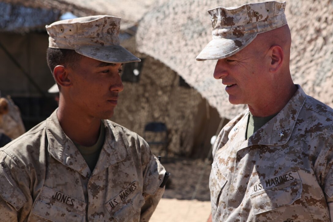 Brigadier Gen. David Ottignon, the commanding general of 1st Marine Logistics Group, speaks to Pvt. Anthony Jones, a motor vehicle operator with Combat Logistics Battalion 1, Combat Logistics Regiment 1, while visiting his Marines during Integrated Training Exercise at Forward Operating Base 3 aboard Marine Corps Ground Air Combat Center Twentynine Palms, Calif., Aug. 5, 2015. Ottignon toured the FOB and spoke with his Marines about morale, training and readiness.